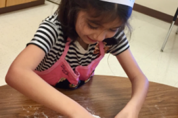 a young boy cutting a cake